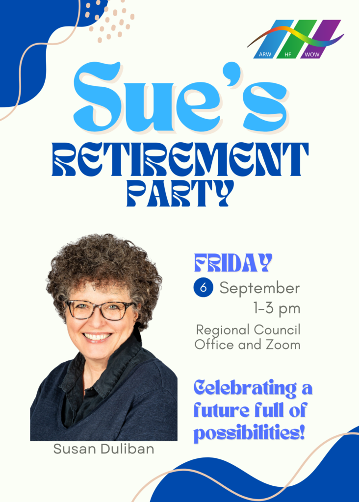 a woman with short brown curly hair wearing glasses and smiling wearing a blue shirt and jacket her name is Sue